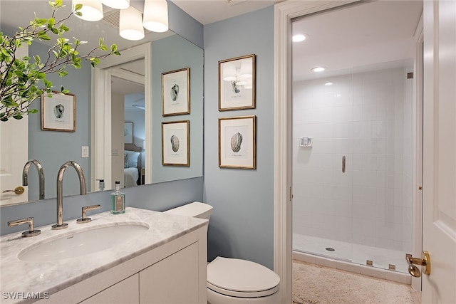 bathroom featuring a shower with door, vanity, and toilet