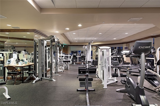 exercise room with a paneled ceiling