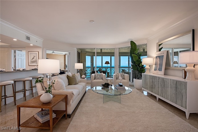 living room featuring a healthy amount of sunlight, carpet floors, and crown molding