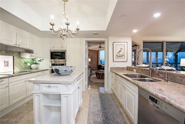 kitchen featuring dishwasher, a center island, and white cabinetry