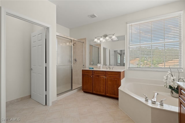 bathroom featuring tile patterned floors, vanity, and shower with separate bathtub