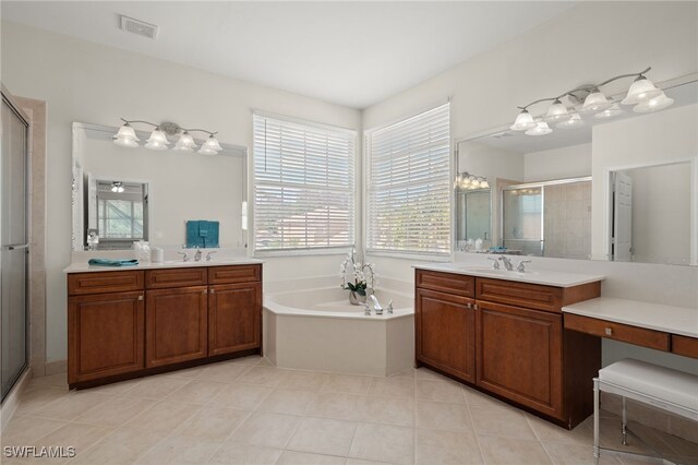 bathroom featuring tile patterned flooring, vanity, and shower with separate bathtub