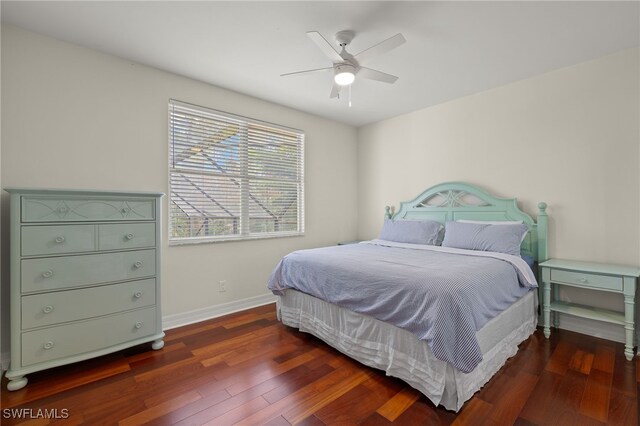 bedroom featuring ceiling fan and dark wood-type flooring