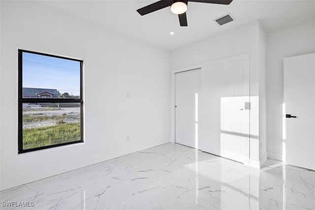 unfurnished bedroom featuring multiple windows, a closet, and ceiling fan