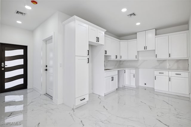 kitchen with white cabinets and backsplash