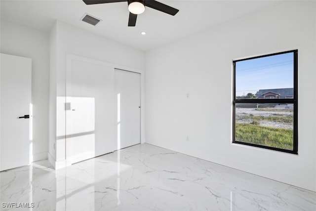 unfurnished room with ceiling fan and plenty of natural light