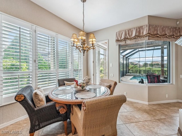 dining space with light tile patterned flooring and a chandelier