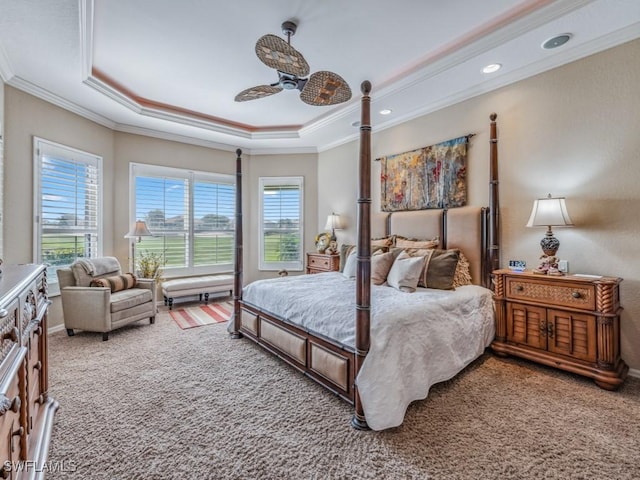 bedroom featuring crown molding, ceiling fan, a tray ceiling, and carpet floors