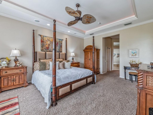 bedroom with crown molding, carpet floors, a raised ceiling, and ceiling fan