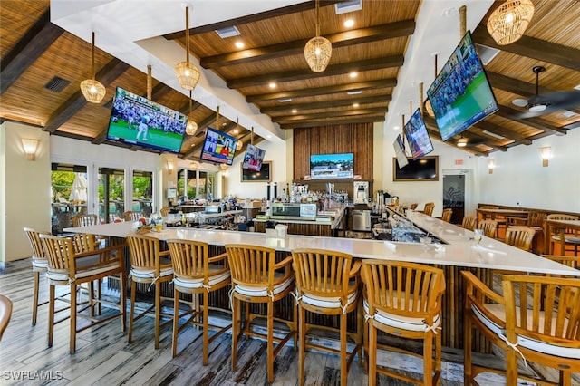 bar with wood ceiling, wood-type flooring, high vaulted ceiling, hanging light fixtures, and beam ceiling