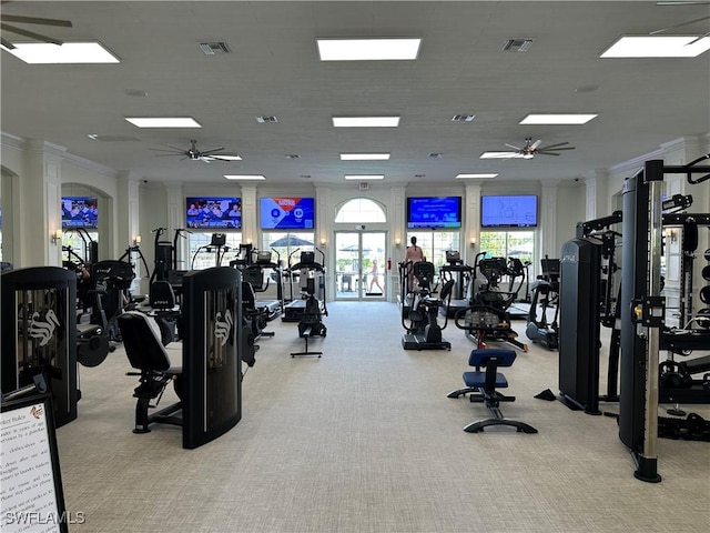 gym with ornamental molding, light colored carpet, and ceiling fan