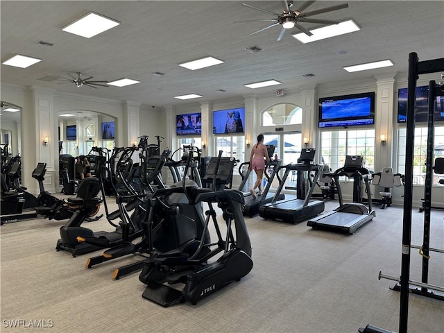 exercise room with ceiling fan, ornamental molding, and carpet