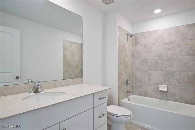 full bathroom featuring vanity, toilet, and tiled shower / bath