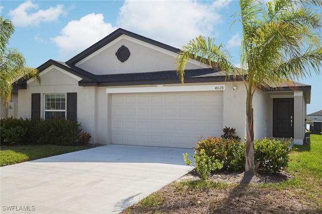 single story home with a garage and cooling unit