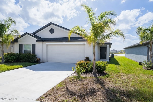 single story home with a front yard and a garage