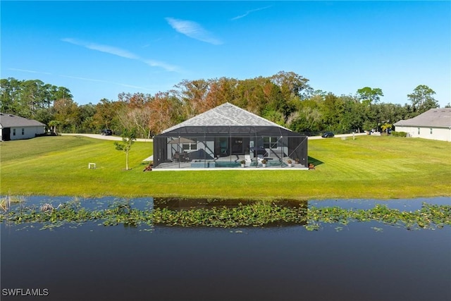 back of house with a water view, a lanai, a yard, and a swimming pool