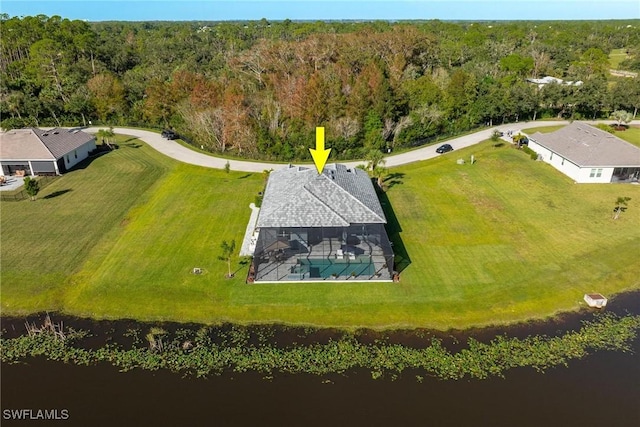 birds eye view of property featuring a water view and a wooded view