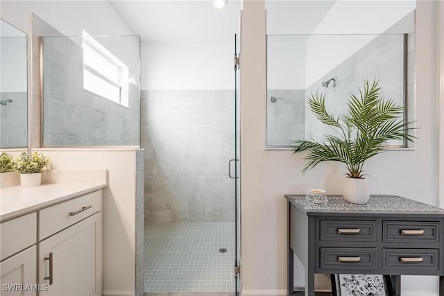 full bathroom with a stall shower and vanity