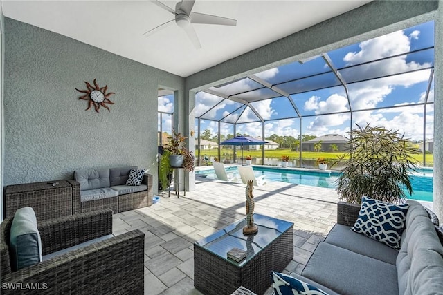 view of patio with outdoor lounge area, a lanai, a ceiling fan, and an outdoor pool