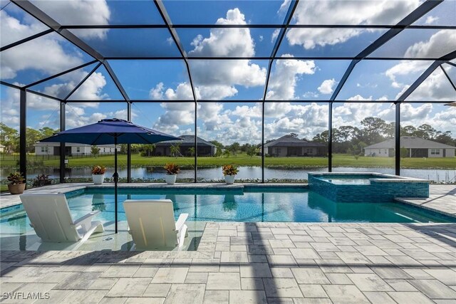 view of swimming pool with a lanai, a patio area, a water view, and an in ground hot tub