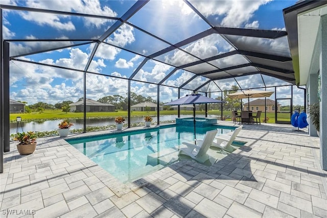 view of swimming pool featuring a lanai, a water view, a pool with connected hot tub, and a patio