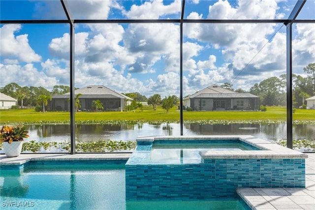 pool with a yard, glass enclosure, a water view, and a hot tub