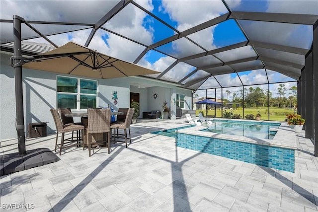 view of pool featuring a lanai, a patio area, and an in ground hot tub