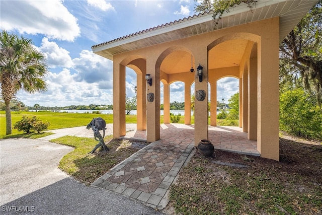 surrounding community with a yard and a water view