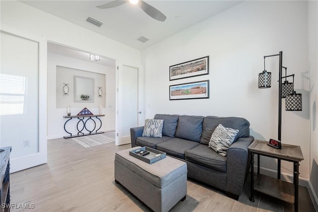 living room featuring ceiling fan and light hardwood / wood-style floors