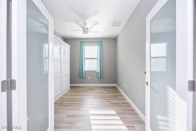 spare room with light hardwood / wood-style floors and ceiling fan