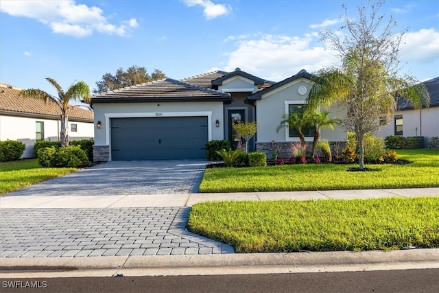 view of front of home with a front yard and a garage