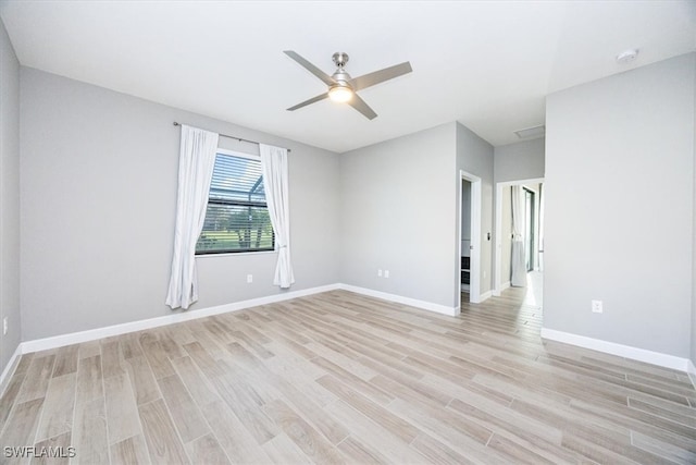 empty room featuring ceiling fan and light hardwood / wood-style flooring