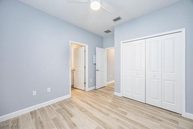 unfurnished bedroom with a closet, light wood-type flooring, and ceiling fan