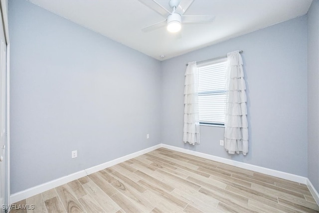 empty room with ceiling fan and light hardwood / wood-style flooring