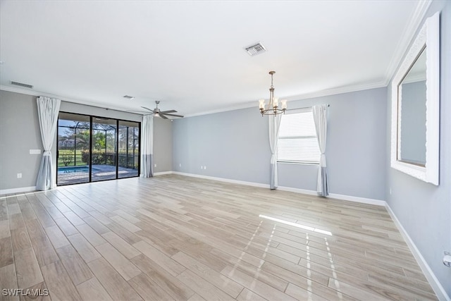 empty room featuring light hardwood / wood-style floors, ornamental molding, a wealth of natural light, and ceiling fan with notable chandelier