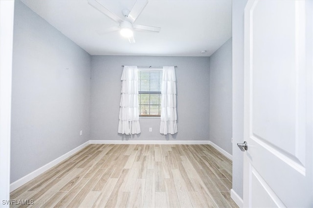 empty room with ceiling fan and light wood-type flooring