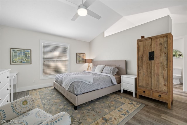 bedroom with ensuite bath, lofted ceiling, dark wood-type flooring, and ceiling fan