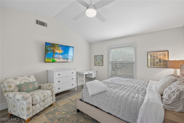 bedroom featuring hardwood / wood-style floors, vaulted ceiling, and ceiling fan