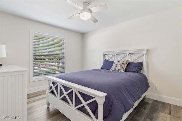 bedroom with dark hardwood / wood-style floors and ceiling fan