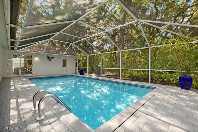 view of pool with a patio and a lanai