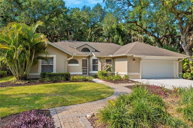 single story home featuring a front yard and a garage