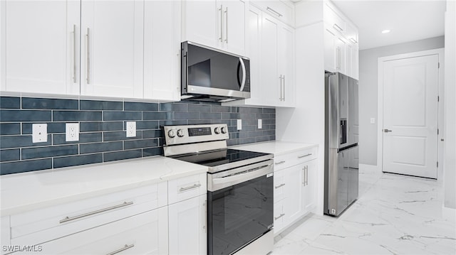 kitchen featuring decorative backsplash, white cabinetry, and appliances with stainless steel finishes