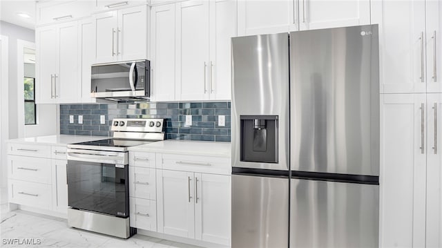 kitchen featuring white cabinets, decorative backsplash, and appliances with stainless steel finishes