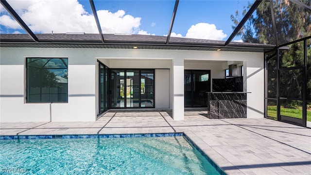 back of house with a lanai and a patio