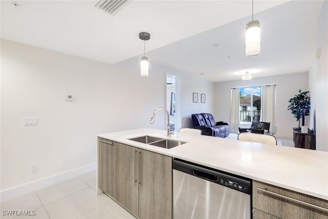 kitchen with hanging light fixtures, stainless steel dishwasher, sink, and light tile patterned floors