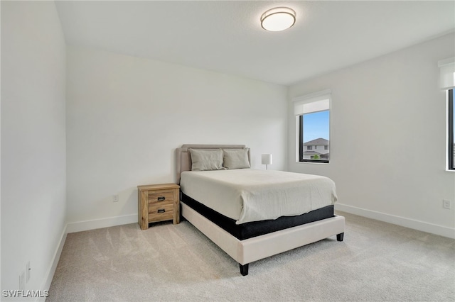 bedroom featuring light colored carpet