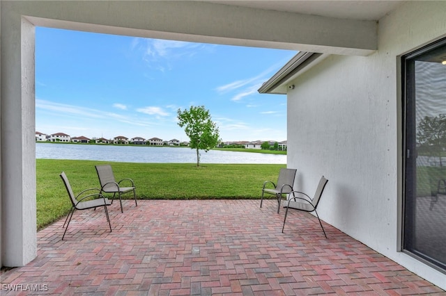 view of patio with a water view