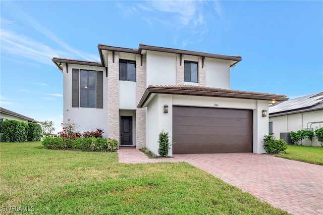 view of front of property featuring a front lawn and a garage