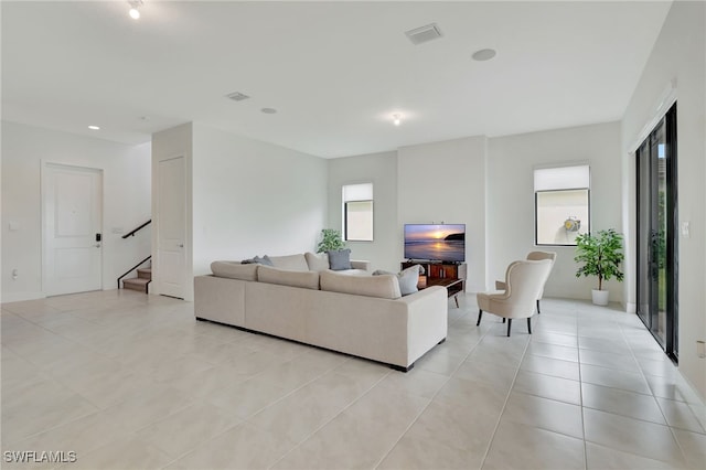 living room with a wealth of natural light and light tile patterned floors