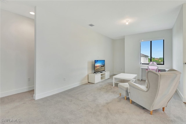 living area featuring light carpet